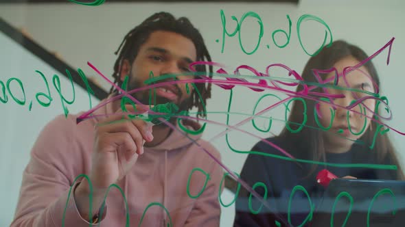 Freelance Team Drawing Data on Transparent Glass Board alt