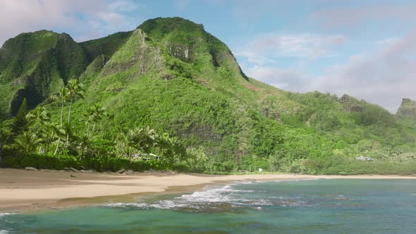 Aerial Flying Backwards Above Ocean with Beautiful Green Mountains on Background alt