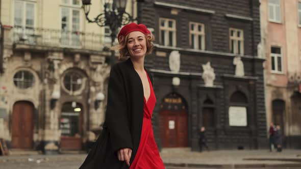 Sexy Woman In Red Walks The City Street. alt