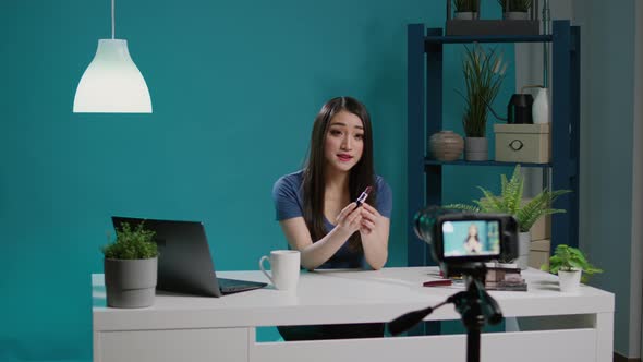 Beauty Influencer Doing Makeup Product Review on Videoblog alt