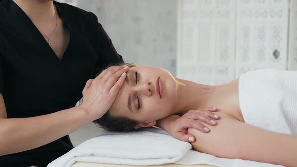 Cute Handsome Woman During Massage on the Face in the Massage Salon alt