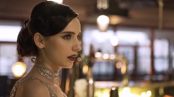 Closeup Portrait of a Young Attractive Woman in a 1920s Style at the Bar alt