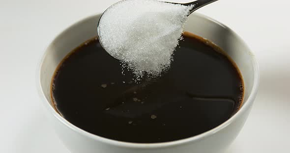 Sugar Falling into Bowl of Coffee, Slow Motion 4K alt