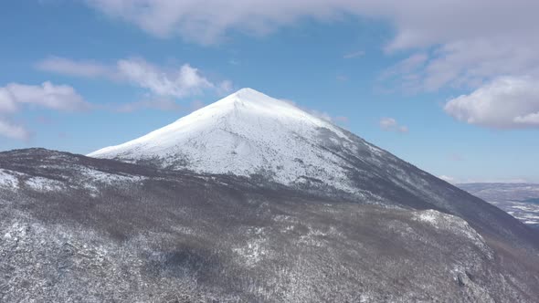 Clouds passing above the snowed Rtanj mountain 4K drone video alt