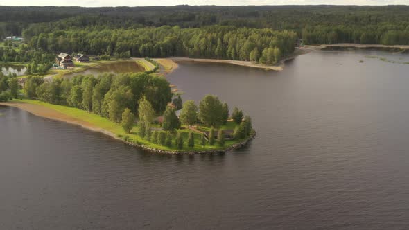 Small island with trees and houses surrounded by water