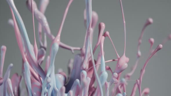 Pink And Blue Paint Flying Into Air Creating Abstract Patterns alt