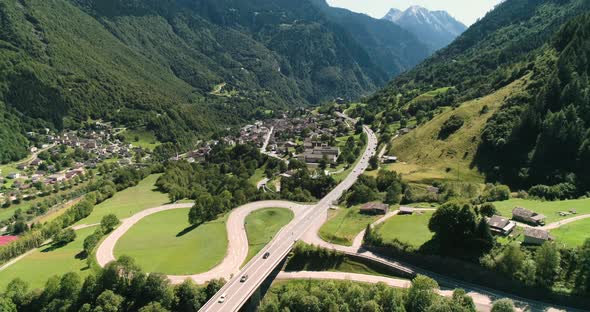 Aerial View of Cars Driving a Mountain Road Valley in Alps, Switzerland  alt