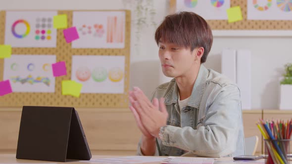 Asian businessman talking on web conference with client using laptop webcam alt