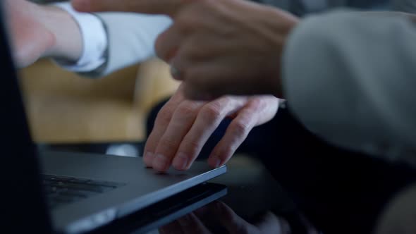 Coworkers Arms Pointing Laptop in Hotel Closeup alt