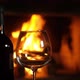 bottle of red wine in front of fireplace against the background of burning wood. - VideoHive Item for Sale