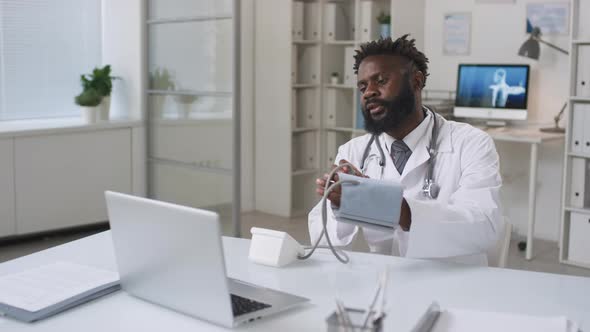 African American Doctor Working With Patient Online alt