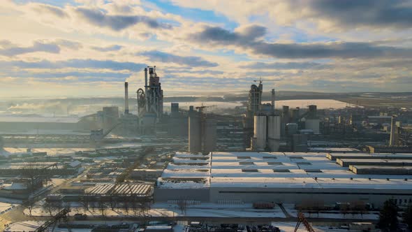 Aerial View of Cement Plant with High Factory Structure and Tower Crane at Industrial Production alt
