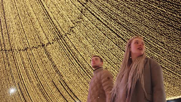 Young Couple at Christmas Celebrating Outdoors alt