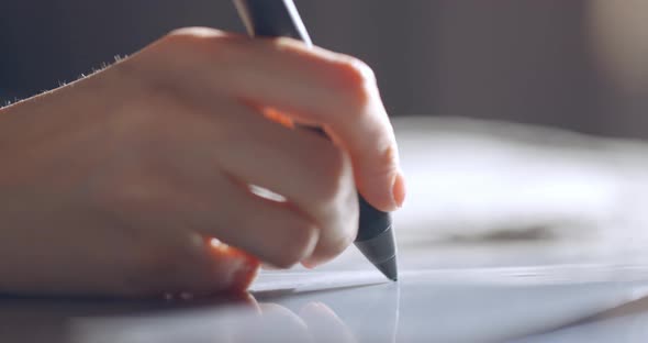 Close Up View of Woman Hand Using Digital Tablet Drawing with Stylus Pen alt