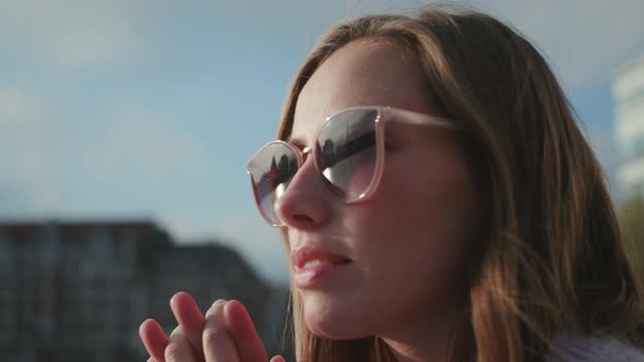 Brunette In Sunglasses With Hands Clasped