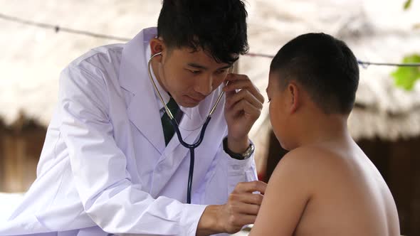 Doctor Examining A Rural Child Boy alt