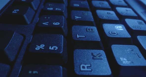 Computer Keyboard Illuminated By Blue Light alt