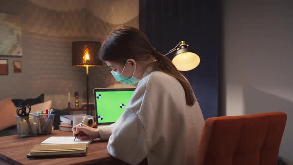 Happy Woman in Mask Communicating Using Laptop Computer for Video Chatting with Friends Remote Work alt