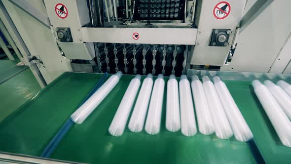 Plastic Cups Being Automatically Placed Onto a Conveyor alt