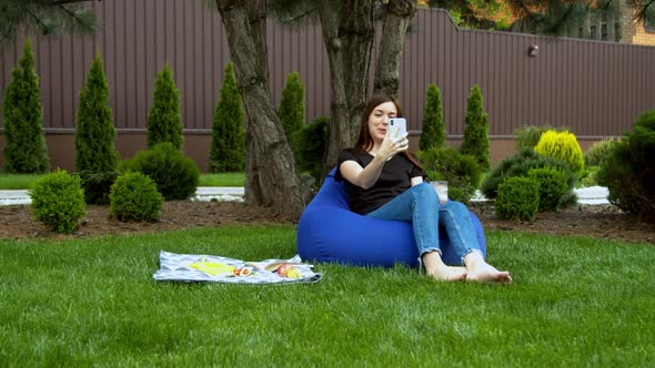 Young Woman Having Video Call in Garden