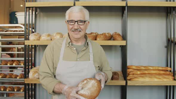 Portrait of Happy Elderly Baker alt
