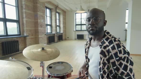 Portrait of Black Drummer at Drumset in Studio alt