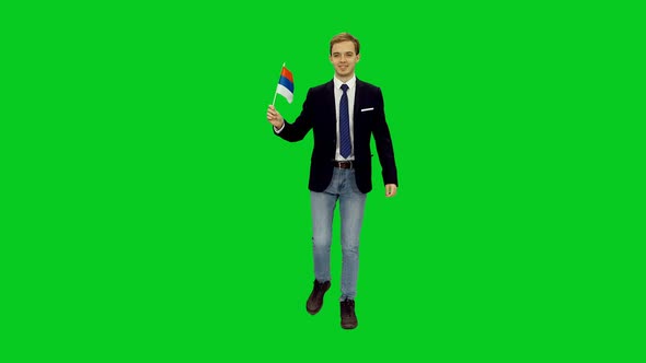 Young Man In Suit Jacket Walking With Flag of Russia on Green Screen