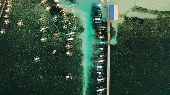 Pier with Boats in the Sea, Aerial View. General Luna, Siargao Island alt