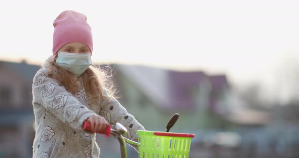 Little Girl Wearing Medical Mask During Coronavirus Epidemic alt