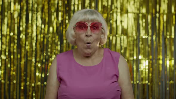 Portrait of Excited Wondered Senior Old Woman Looking Around, Opening Her Mouth in Amazement alt