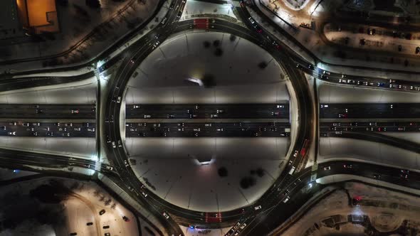 Aerial View Above Traffic at a Roundabout on a Late Winter Evening During Rush Hour
