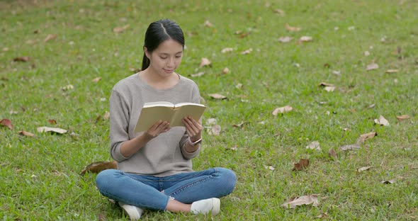 Young Woman Read a Book at Park alt