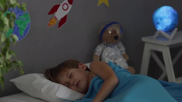 Happy child sleeping at home. Slow motion