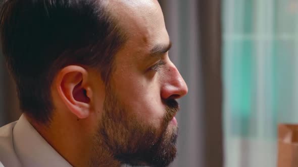 Close Up of Businessman Biting From a Burger alt