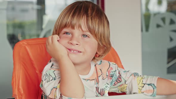Closeup of a Blueeyed Happy Child Having Fun on a Sunny Weekend Morning alt