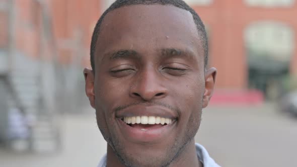Close Up of Face of African Man Smiling at Camera alt