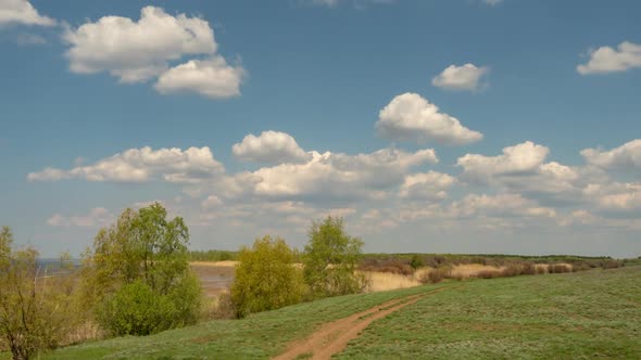 View of Clouds Above the Green Field