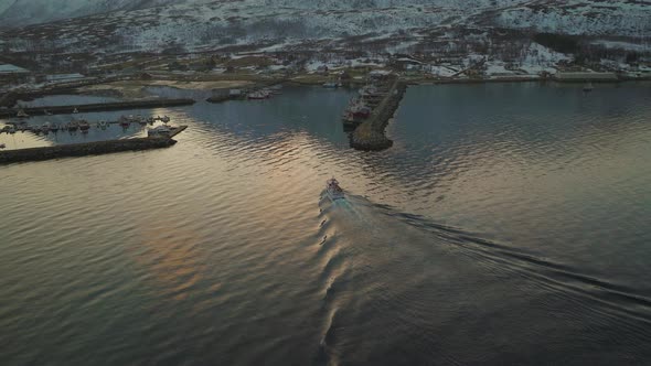Fishing Boat Cruising Through Quiet Waters Near Tromvik Village - Aerial shot alt