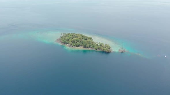 Aerial: flying over tropical island Banda Islands Maluku Indonesia Maldives Poly alt