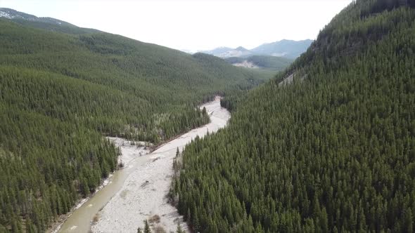 Aerial Footage Edge Of Tree'd Mountain & Creek
