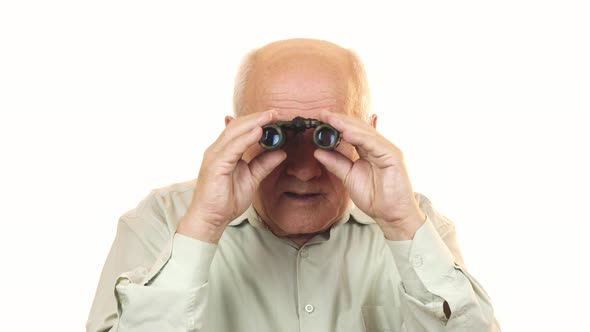 Old Man Using Binoculars Looking Surprised To the Camera alt