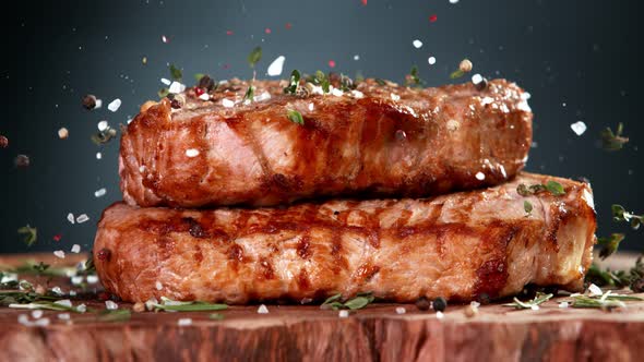 Super Slow Motion Shot of Seasoning Falling on Grilled Double Beef Meat on Wooden Board at 1000Fps alt
