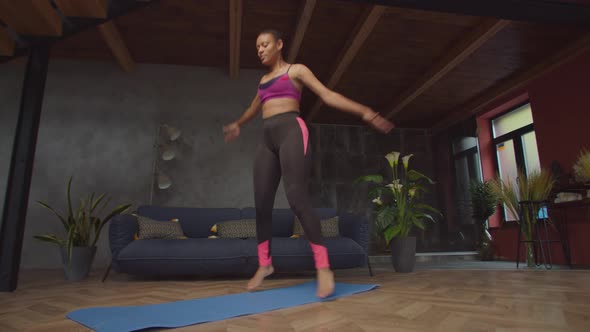 Fitness African Female Doing Jumping Jack Exercise alt