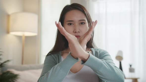 Beautiful Asian Woman Saying No or Denial by Making X Hand Shape