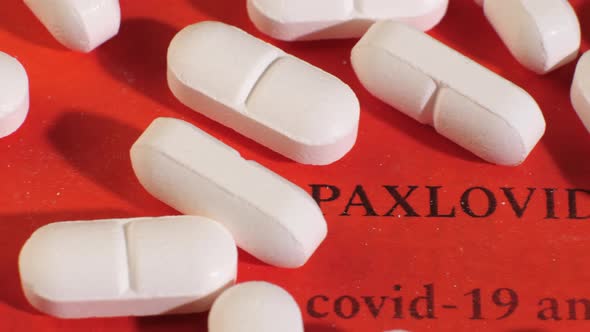 Closeup Shot of Pills on Red Background with Black Text alt