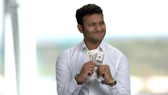 Businessman Trying To Unlock His Handcuffs. alt