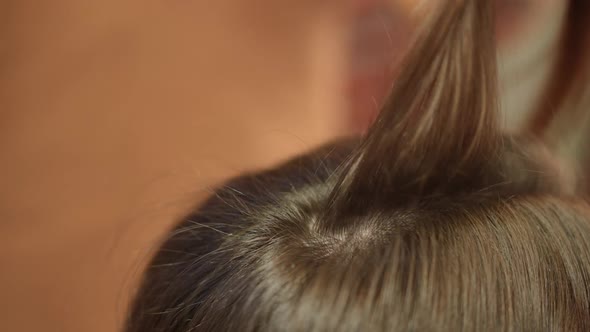 Closeup Hair Strand Combing and Curling with Flat Iron alt