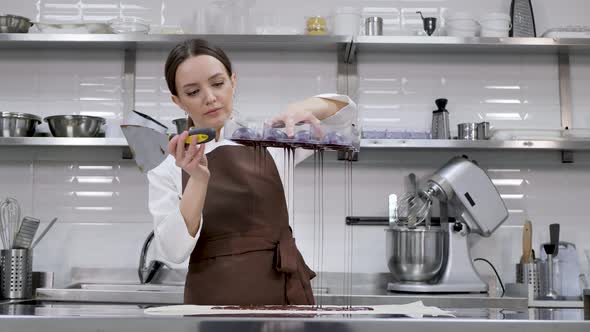 Chef or Chocolatier Makes Sweet Chocolates in a Professional Kitchen