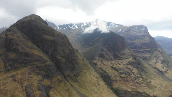 Aerial view of  highlands in Scotland, with clouds over the famous mountains alt