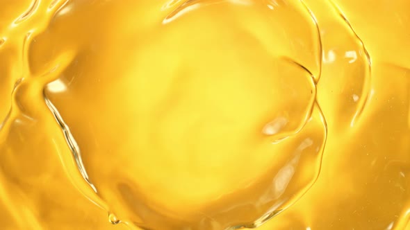 Super Slow Motion Shot of Swirling Golden Oil Liquid at 1000Fps alt